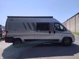 a silver van that is parked on the side of the road