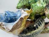 a ceramic sculpture of a frog and a turtle on a branch