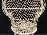 a white wicker chair on a black background with a black background