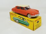 a red toy car sitting on top of a yellow box