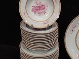 a lot of plates and bowls on the table