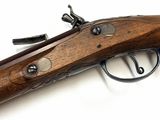 a close up of a rifle on a white surface