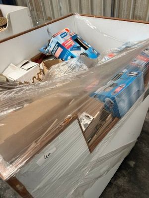 a white refrigerator with plastic wrap on top of it