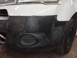 the front bumper of a white van with a black bumper