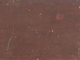 a brown piece of luggage sitting on top of a table