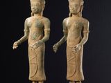 two statues of a man and a woman standing next to each other