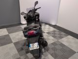 a motorcycle parked in a room with a checkered floor