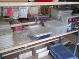 many plastic containers on a shelf in a room