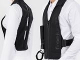 two men in white shirts and black vests posing for a picture