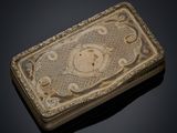 an old silver box with a picture of a monkey on it