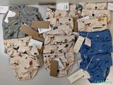 several pairs of baby boy ' s underwear sitting on top of a table
