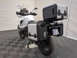 a motorcycle that is parked in a room with a checkered floor