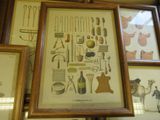 many framed pictures on the wall of this room