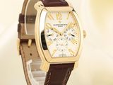 a gold watch with a brown leather strap on a white background