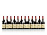 six bottles of red wine lined up in a row
