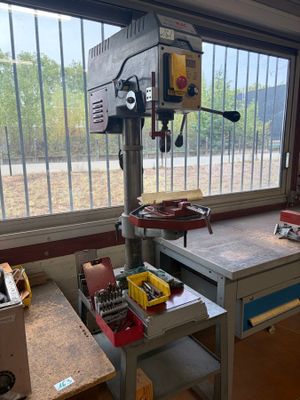 a drill table with a drill on it in a garage