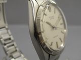 an image of a close up of a wrist watch on a table