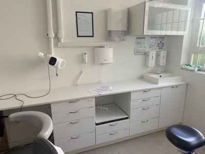 an image of a dentist ' s office with a desk and chair