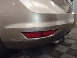 a car that has been painted silver and is parked in a garage