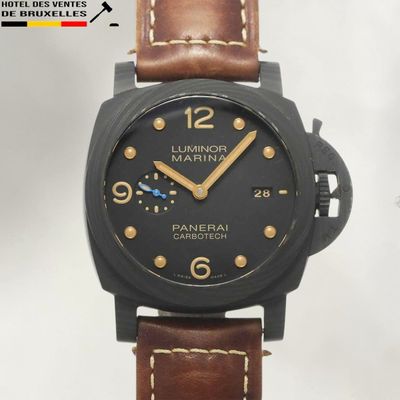 a black watch with brown leather straps on a white background
