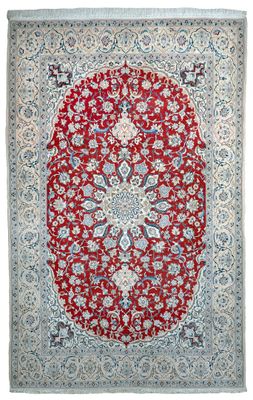 a red and blue rug with a medallion design on it