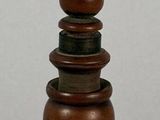 two wooden bowls stacked on top of each other with a bird on top of them