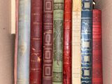 many old books in a box on the shelf