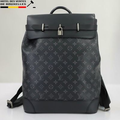 un gros plan d'un sac à dos Louis Vuitton noir posé sur une table