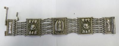 an image of a silver bracelet on a white surface