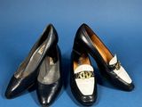 two pairs of black and white shoes on a blue surface