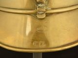 a gold plate with a face on it on a stand