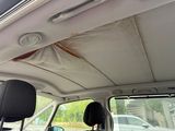 the interior of a car with the sunroof down and a broken roof