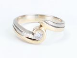 an image of a gold and silver ring with a diamond