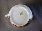 a close up view of a white plate with a brown rim