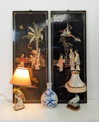 a lamp that is sitting next to a picture on the wall