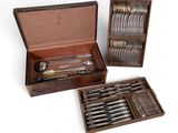 a wooden box with a set of silverware in it