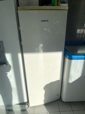a white refrigerator and a blue refrigerator in a kitchen