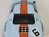 a toy car that is sitting on a white surface