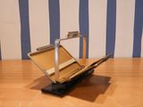a laptop computer sitting on top of a wooden table