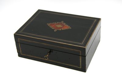 une petite boîte noire ornée d'un motif décoratif