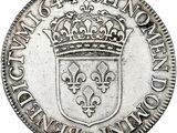 a silver coin with a crown on top of it