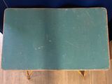 an image of a green table sitting on top of a hard wood floor