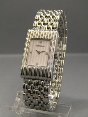 a close up of a wrist watch on a clear stand