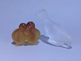 two pieces of fruit sitting on a table next to a plastic bag