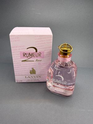 a bottle of perfume sitting next to a box on a table