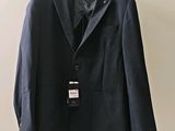 a suit hanging on a hanger on a wall