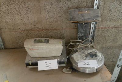 a scale and a blender sitting on a shelf