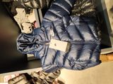 a blue jacket with a tag on it sitting on a table