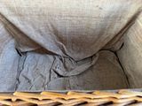 a wicker basket with a cloth inside of it
