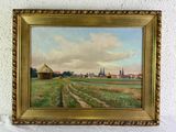 une peinture à l'huile représentant une scène de vie à la ferme, dans un cadre doré, accrochée à un mur blanc